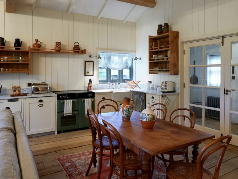 Cosy cabin kitchen area with wooden dining table yy