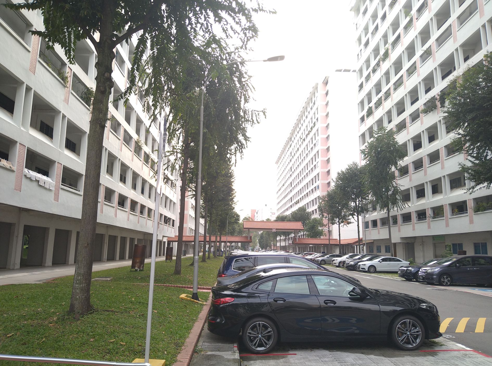 Old Style Open Air Carparks Sometimes Crowded with parents cars when the primary school next to the block lets out in the afternoon 2