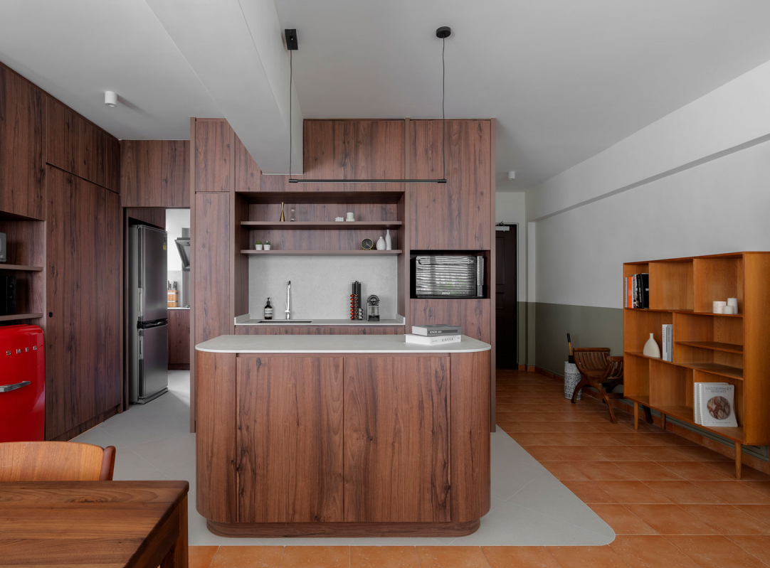 Dry kitchen island and wood-panelled cabinetry in the Cantonment Close flat