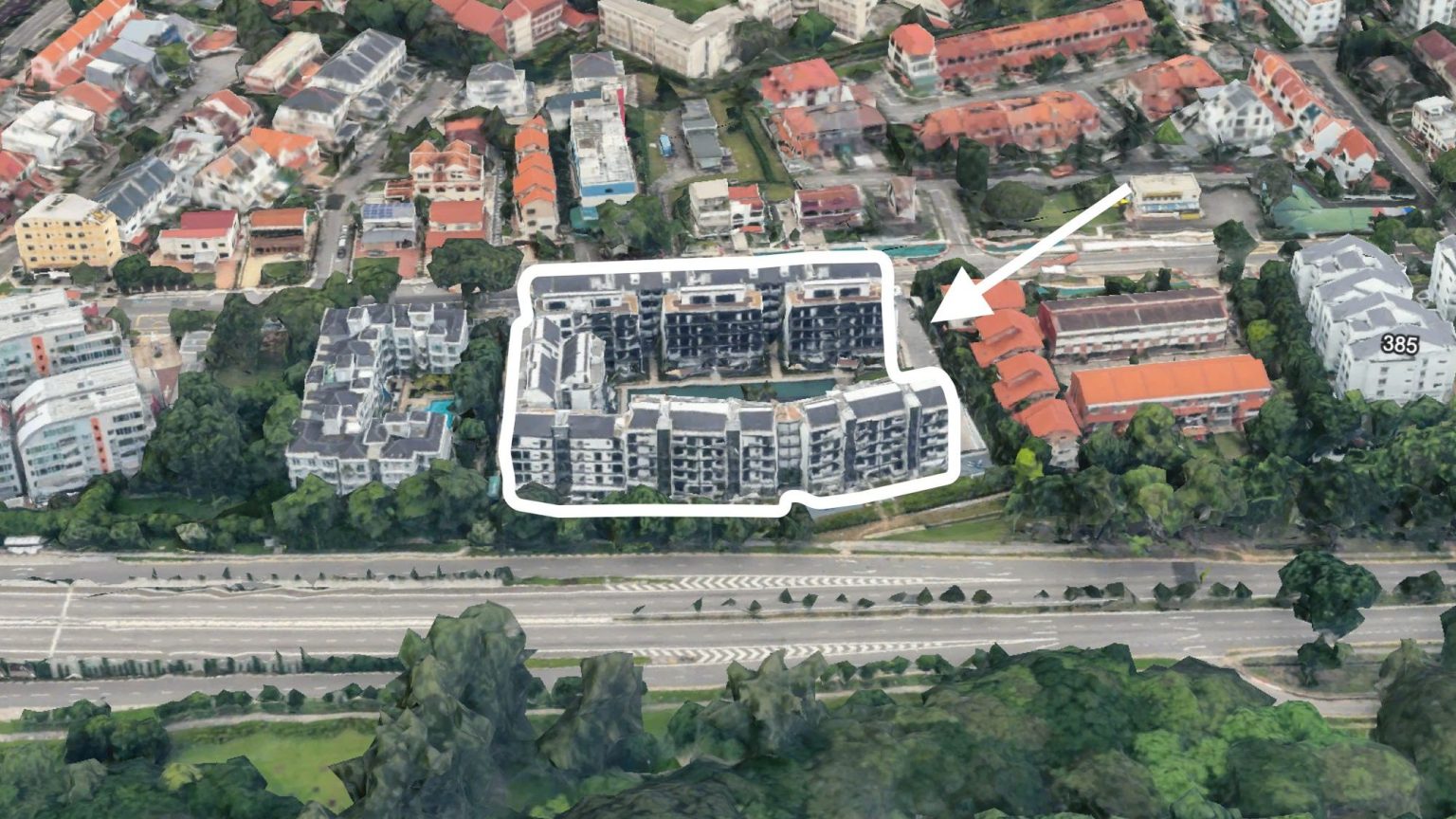 Residential blocks outlined in white, with a white arrow pointing to adjacent low-rise housing blocks