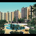 Apartment blocks with a landscaped pool area surrounded by trees and poolside seating