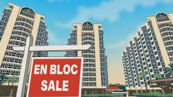 Red en bloc sale signboard in front of high-rise residential apartment blocks under blue sky