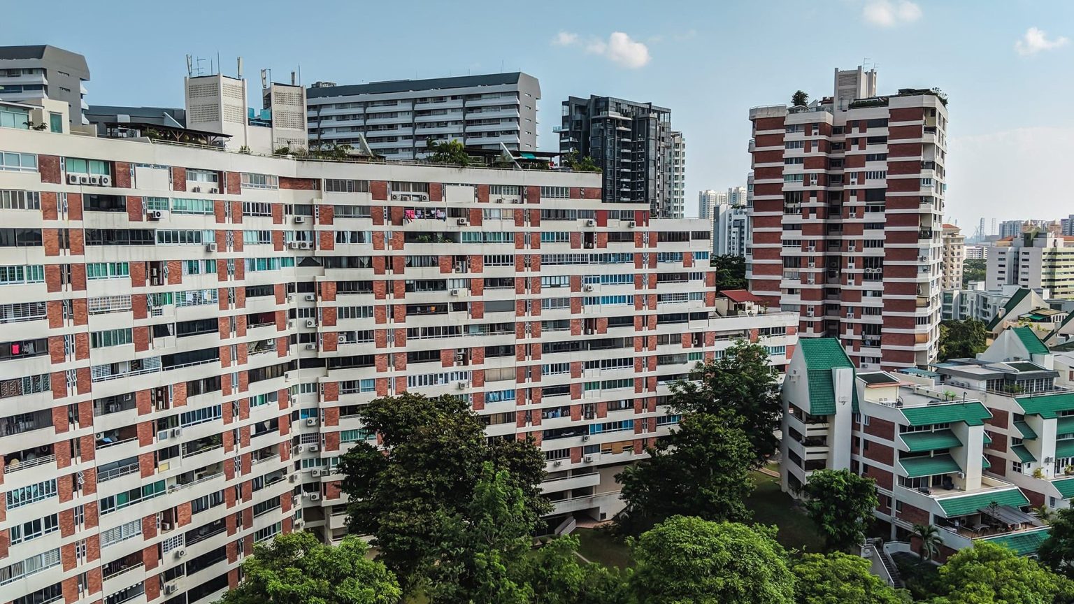 Pandan Valley residential blocks with red brick and white facades surrounded by trees and other buildings