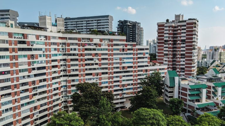 Pandan Valley residential blocks with red brick and white facades surrounded by trees and other buildings