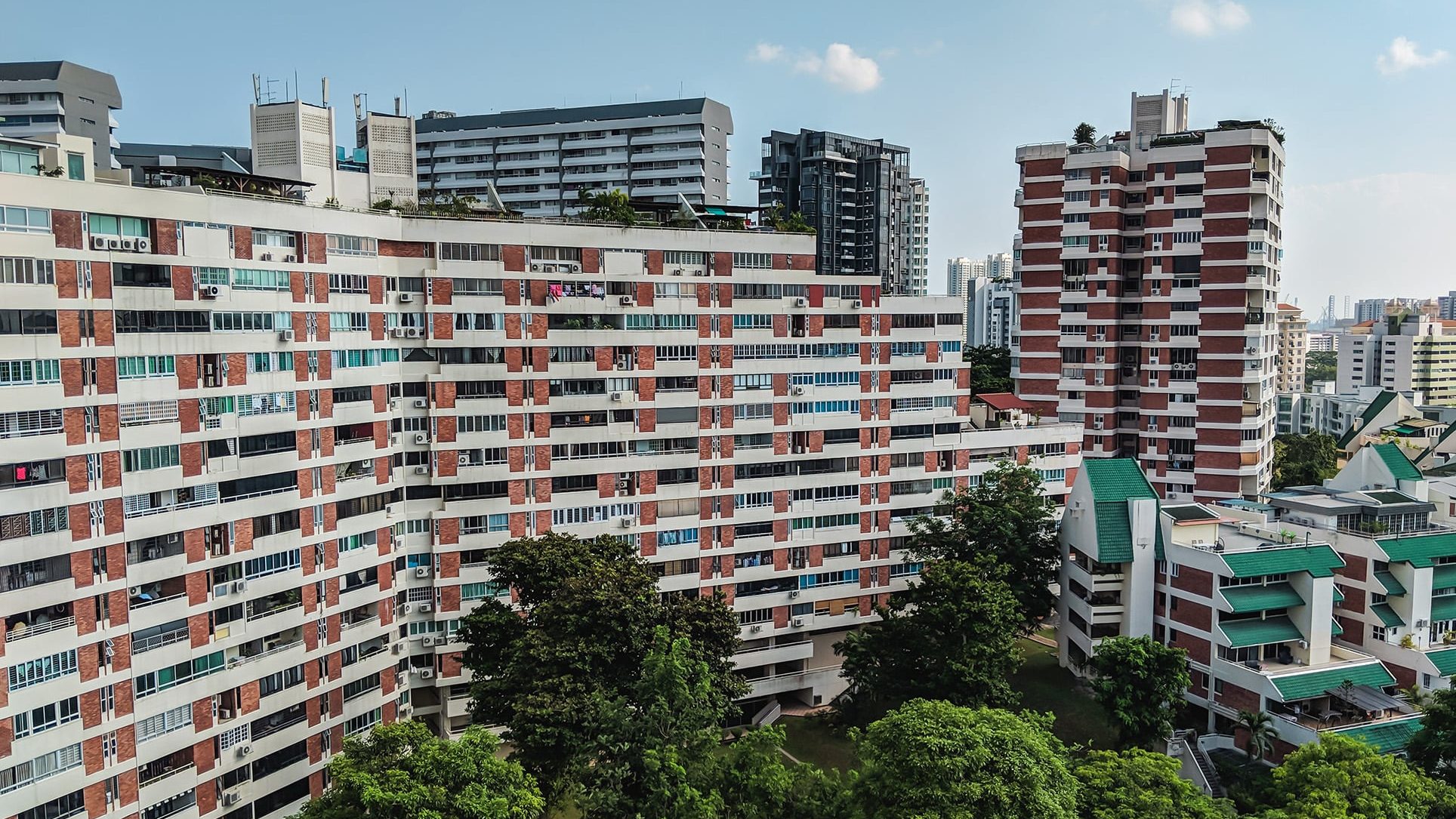 Pandan Valley residential blocks with red brick and white facades surrounded by trees and other buildings