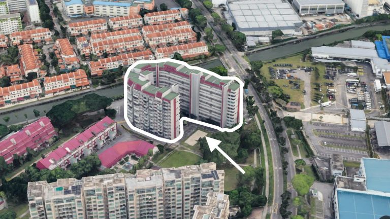 High-rise public housing block outlined with arrow, surrounded by low-rise housing and industrial buildings