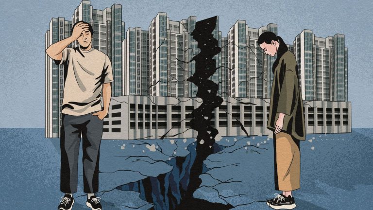 Cracked ground splitting apartment blocks with a worried man and woman standing on either side