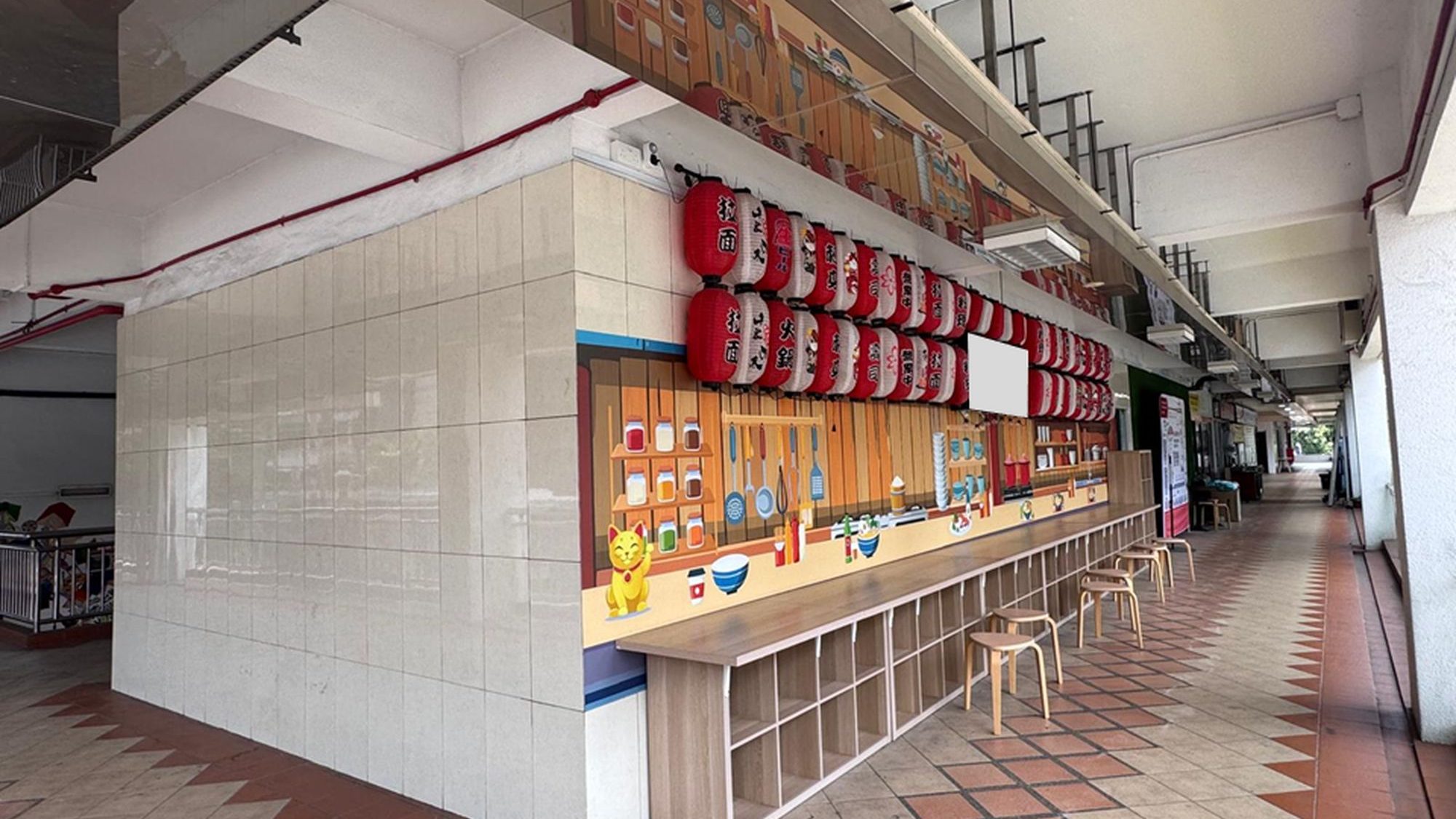 Covered walkway with tiled floor, tiled wall, mural of kitchen utensils, red and white lanterns, stools and cubby shelves