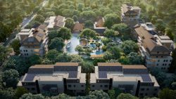 Residential blocks surrounding landscaped gardens with a central pool and playground, set amidst dense trees