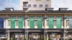 Shophouse facade with green and blue shutters above cafes named Sushi Corner, Montresor, and Bistro