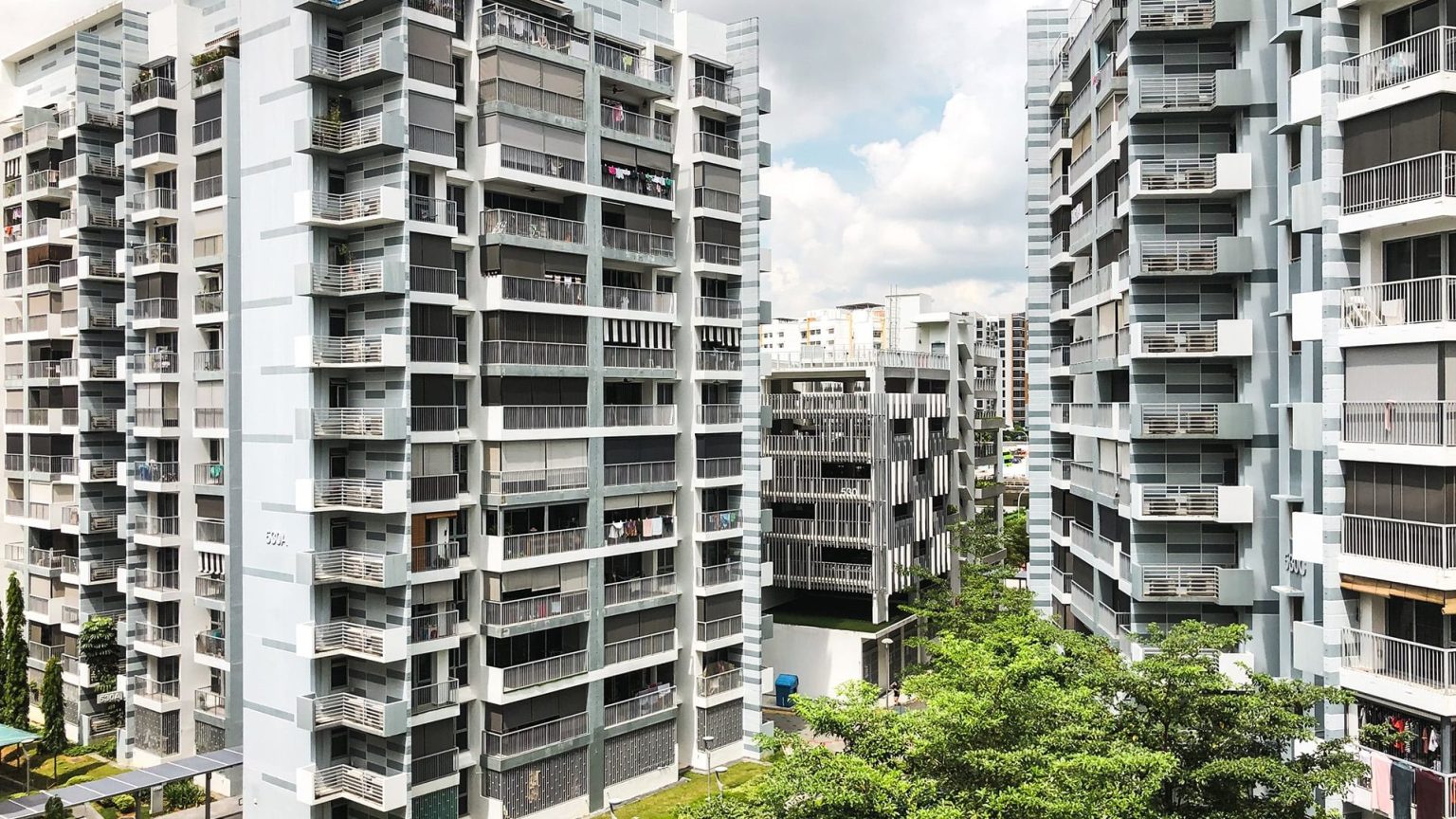 Pasir Ris ONE DBSS residential blocks with balconies and greenery under a partly cloudy sky