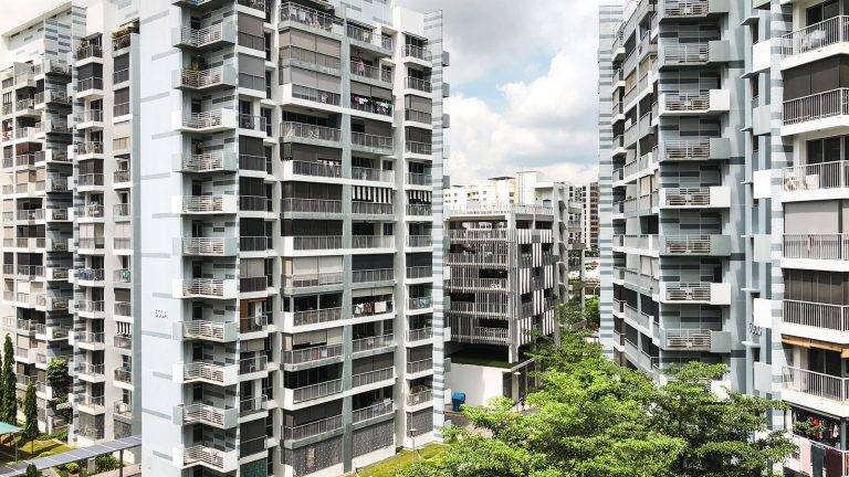 Pasir Ris ONE DBSS residential blocks with balconies and greenery under a partly cloudy sky
