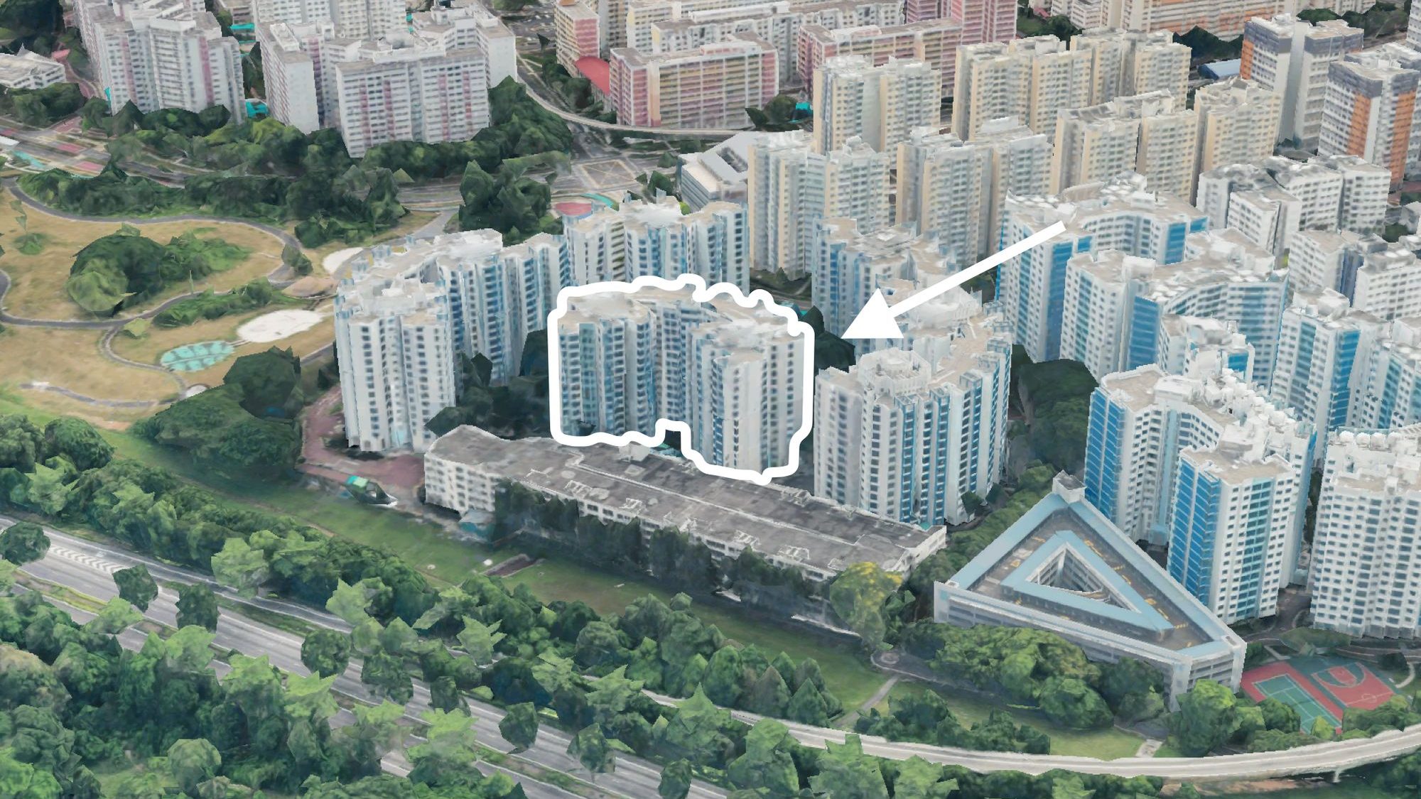 High-angle view of residential blocks with one block outlined and pointed at by white arrow