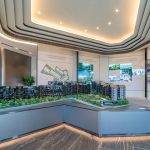 Architectural model of Terra Hill residential blocks displayed in a sales gallery with information panels on the walls