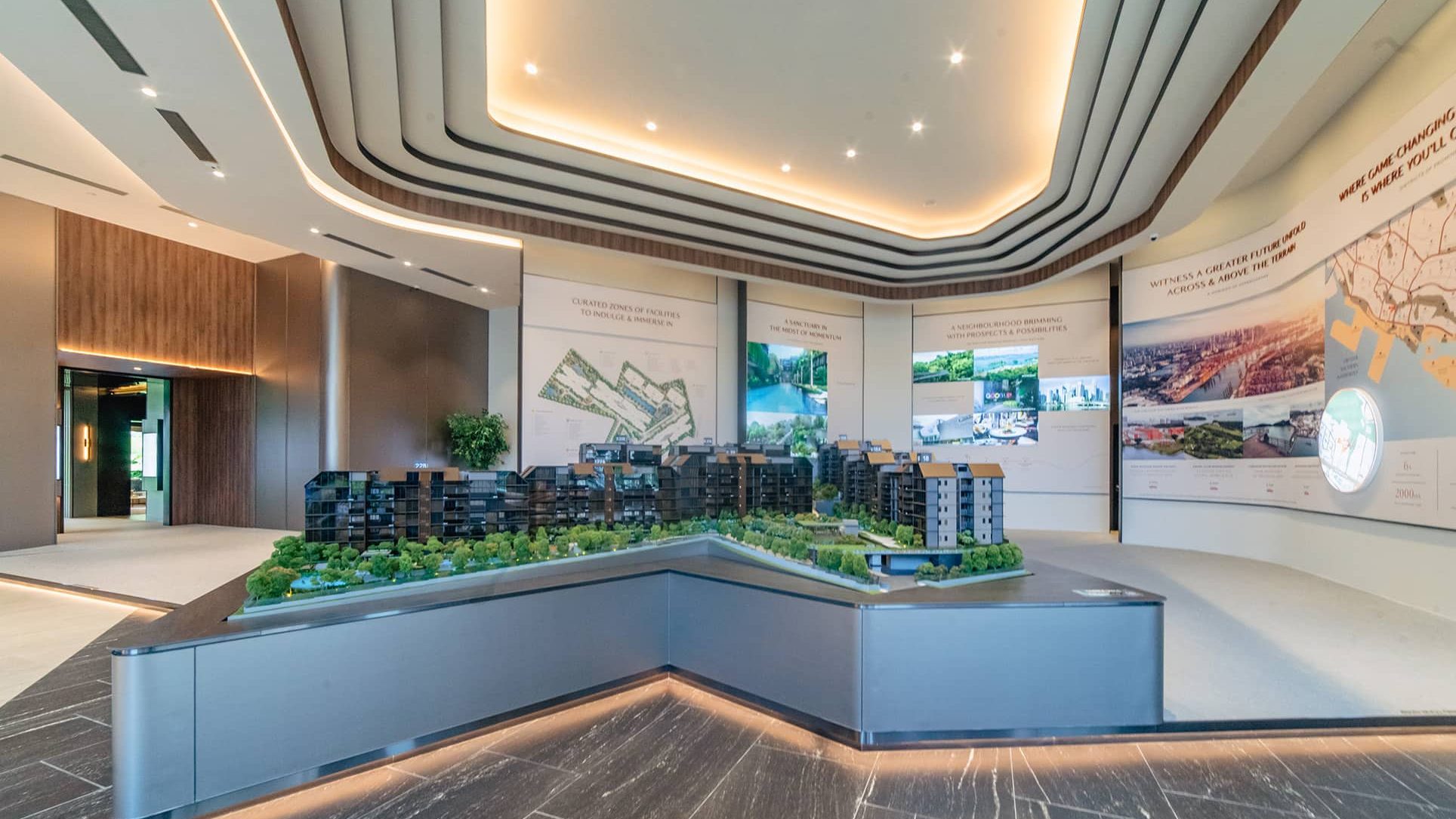 Architectural model of Terra Hill residential blocks displayed in a sales gallery with information panels on the walls