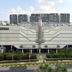 Golden Village Yishun cinema building with housing blocks and trees in the background