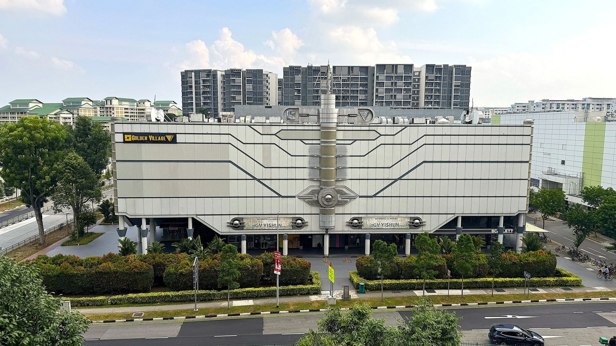 Golden Village Yishun cinema building with housing blocks and trees in the background