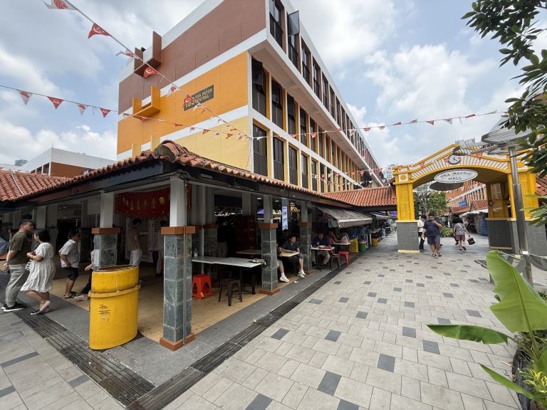 Toa Payoh Central residential block with pedestrian walkway and hawker centre stalls below the building