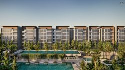 Residential apartment blocks with glass facades and rooftop pool surrounded by trees and lounge chairs