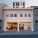 Conserved shophouse with white columns and large glass doors marked Jalan Besar Co Living at upper level