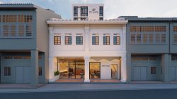 Conserved shophouse with white columns and large glass doors marked Jalan Besar Co Living at upper level