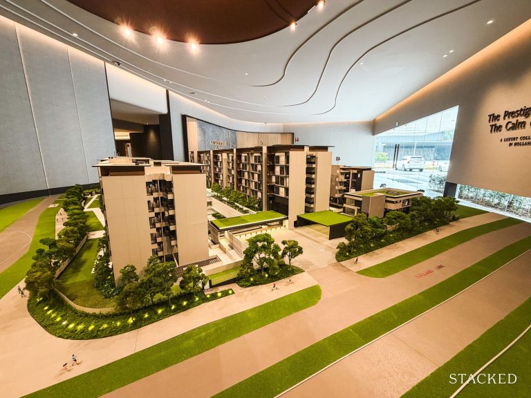 Architectural model of a residential development showing buildings, greenery, paths and a running track in a showroom