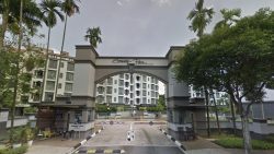 Entrance gate arch with Serenity Park name and white residential blocks visible behind trees