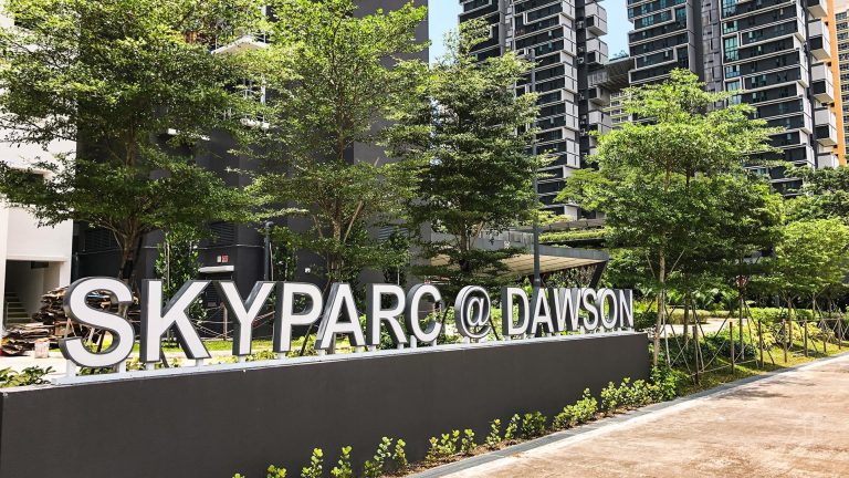SkyParc @ Dawson signboard with greenery and residential blocks in the background