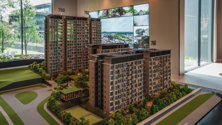 Architectural model of a residential condominium development with numbered towers and surrounding greenery