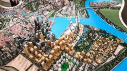 Detailed architectural model of a city centre with high-rise buildings, a river, bridges and green spaces