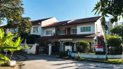 Terraced house with tiled roof and gated porch in a leafy neighbourhood with Singapore flag displayed on fence