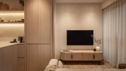 Living room with wall-mounted TV, rattan TV console, beige sofa, and wooden cabinetry next to sheer curtains