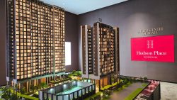 Scale model of Hudson Place Residences apartment blocks with illuminated windows and landscaped grounds