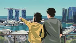 Two people on a balcony overlooking Marina Bay Sands and Singapore skyline with waterfront buildings