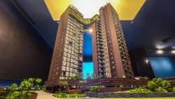 Scale model of Arina East Residences showing two connected apartment towers with greenery and pathways