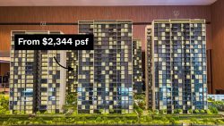 Scale model of residential apartment blocks numbered 59, 57, and 55 with pricing label on block 59
