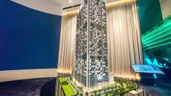 W Residences Marina View architectural model displayed indoors with surrounding trees and roads