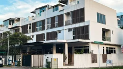 Corner terrace house with white exterior walls, wooden window panels, and balconies at Seletar Green Avenue