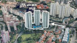 Aerial view of high-rise residential blocks outlined with white and an arrow pointing to them among surrounding buildings and greenery