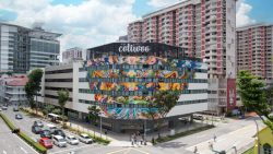 Colivoore commercial building with colourful mural on shopping mall facade near residential blocks and busy road junction