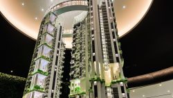 One Pearl Bank architectural model under circular ceiling light with illuminated building details and green spaces