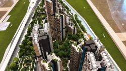 Detailed scale model of high-rise residential apartment blocks with green spaces and water features