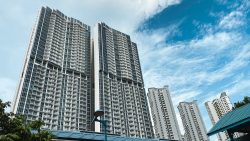 Stirling Residences apartment blocks with curved balconies against a blue sky with scattered clouds