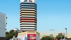 Sim Lim Tower commercial building with coloured horizontal bands and street view in front