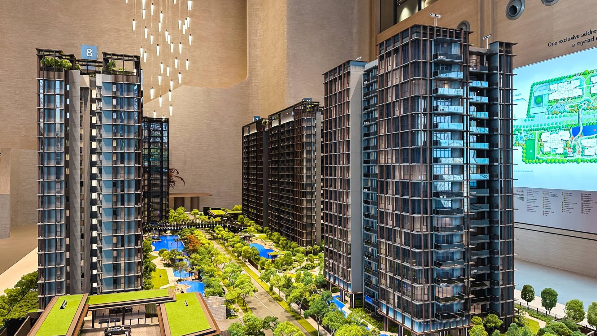 The Continuum residential block models featuring landscaped gardens and water features in a sales gallery