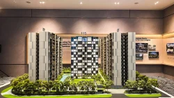 Altura EC scale model showing multiple apartment blocks, green landscaping and a central pool area indoors