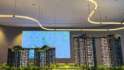 Scale model of Sora apartment blocks with map display and curved ceiling light in sales gallery