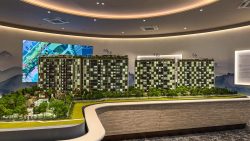 Canberra Crescent Residences scale model showing four residential blocks surrounded by greenery inside showroom