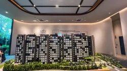 Scale model of Lumina Grand EC residential blocks with greenery and facilities in a showroom