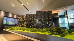 Architectural model of Lentor Mansion residential blocks with trees in foreground inside showroom